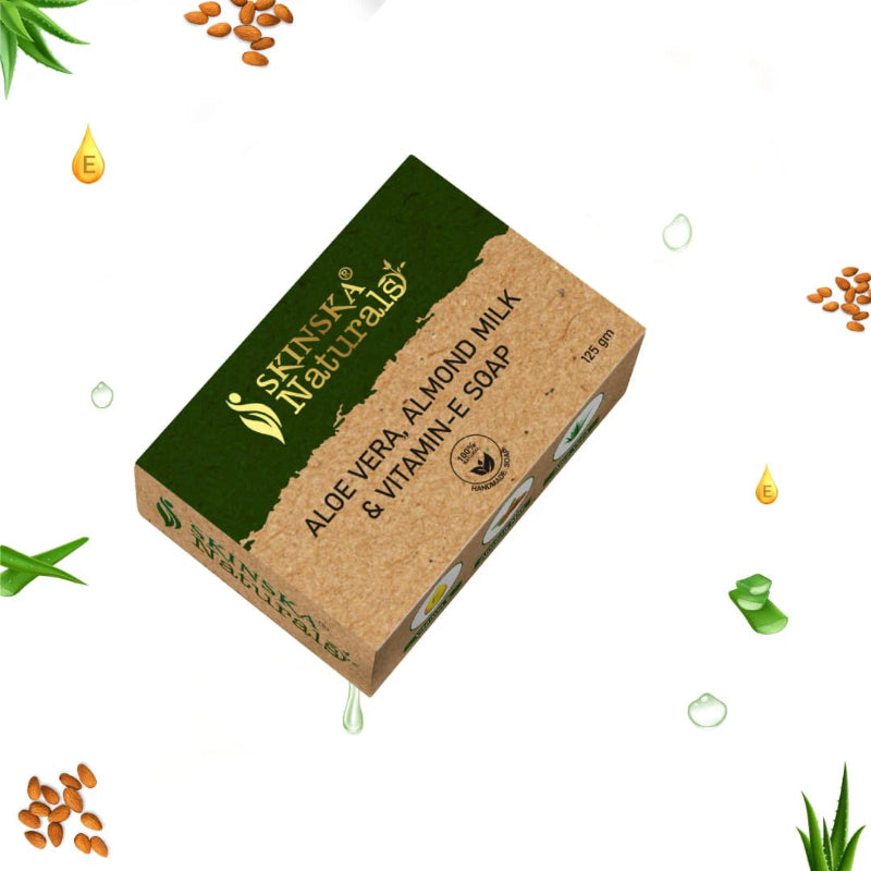 A bar of SKINSKA NATURALS handmade soap with Aloe Vera, Almond Milk, and Vitamin E, displayed with decorative elements like drops of water and aloe vera leaves.
